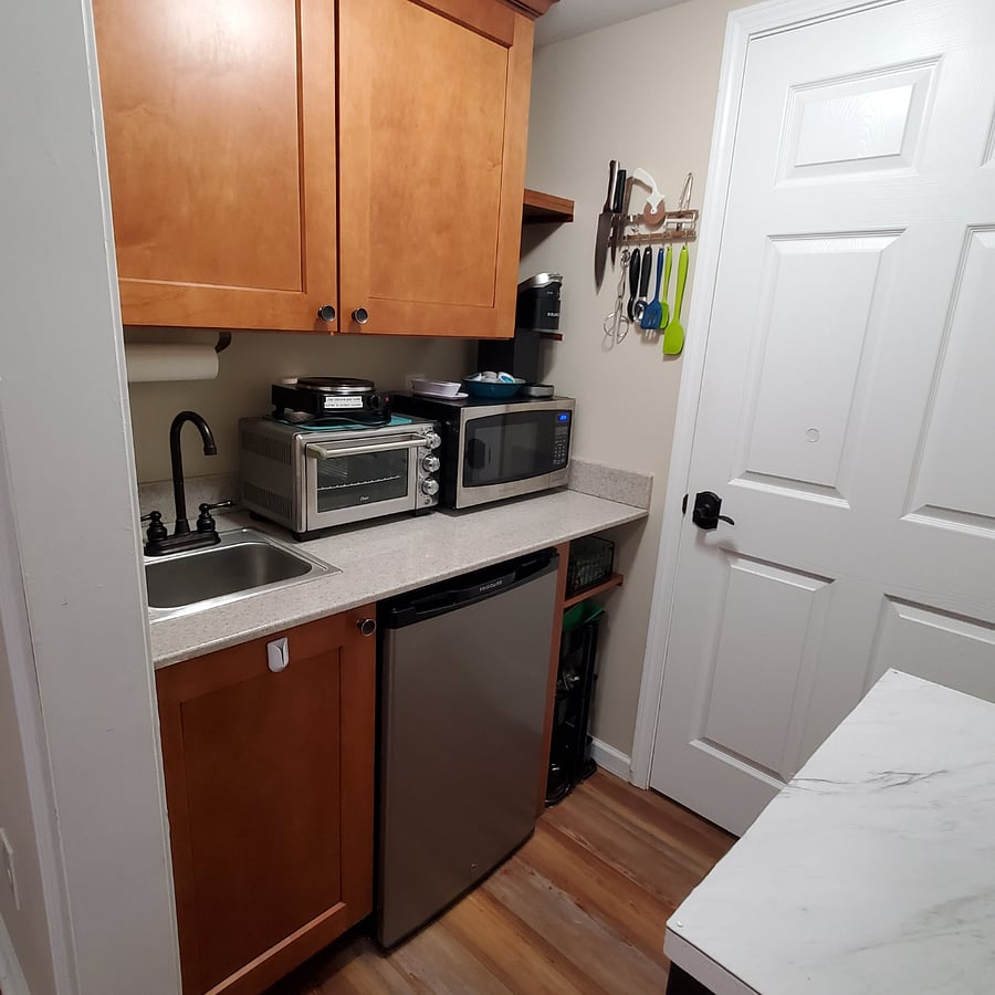 Kitchenette showing sink, mini frig, toaster oven, electric burner, micro and Keurig coffee maker