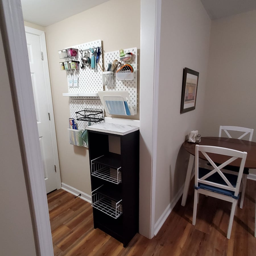 Kitchenette opposite wall showing storage and cooking essentials.