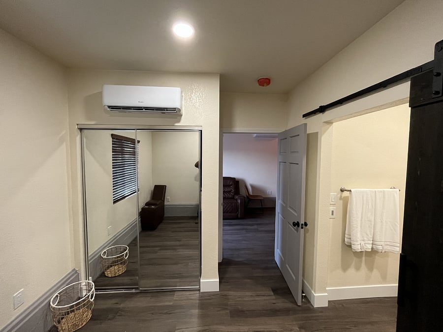 View from bed area of closet and bathroom entrance to the right.