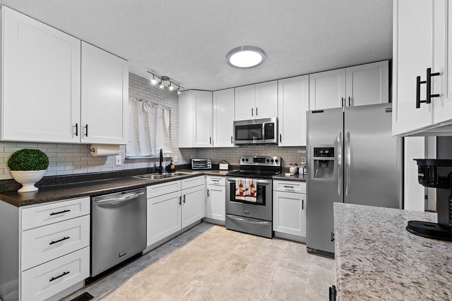 Fully equipped kitchen with stainless steel appliances.