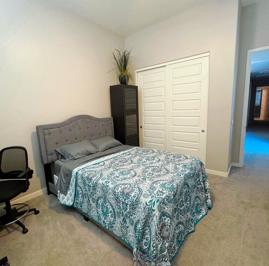 South bedroom with queen bed and shared bathroom.