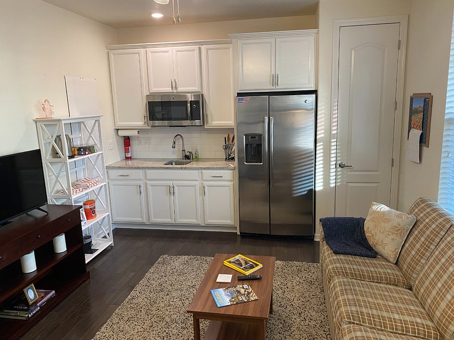 Kitchenette off living room with full size refrigerator and freezer.