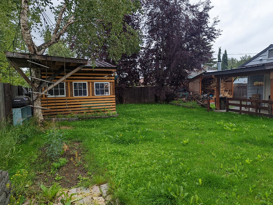 2 sheds with an outdoor, covered woodshop space