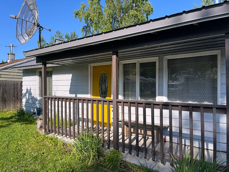 A covered porch on the front yard with solar lights the guide your way at night