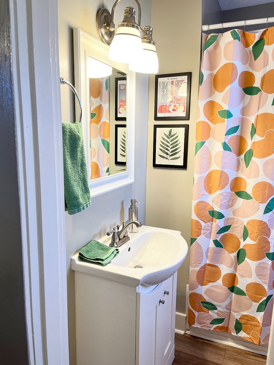 Sparkling clean bathroom with full tub/shower.