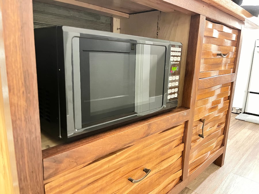 Microwave tucked neatly into the kitchen island.