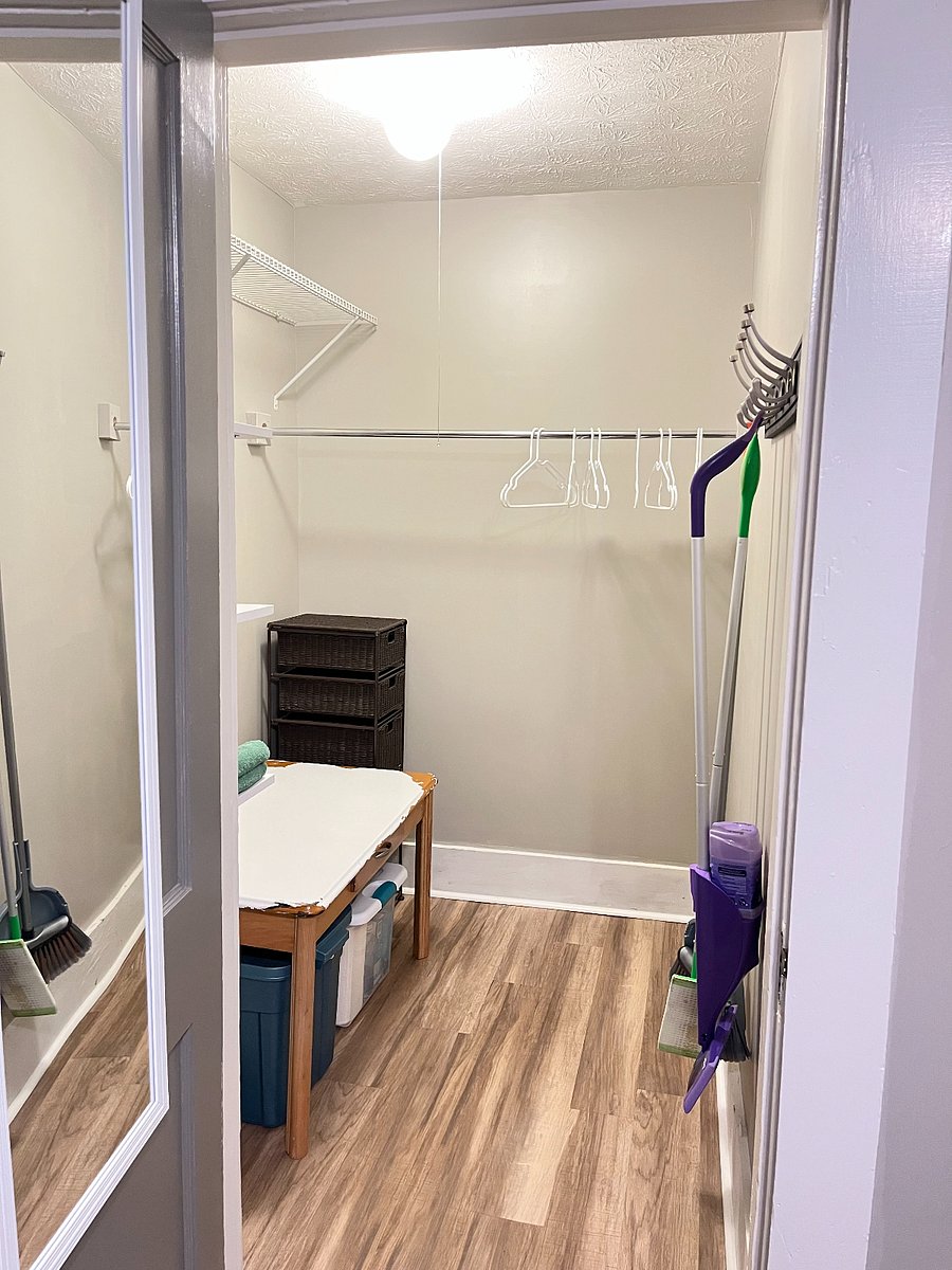 Large walk-in closet in back bedroom with plenty of storage space and extra cleaning supplies.