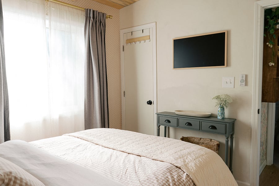 View from the bed. Samsung the frame tv in view and hutch below