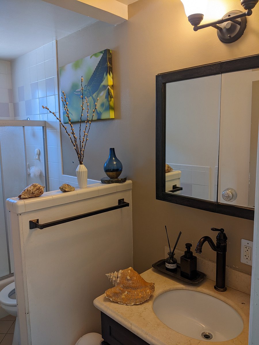 A bathroom with a lot of storage and shelves cabinets spaces