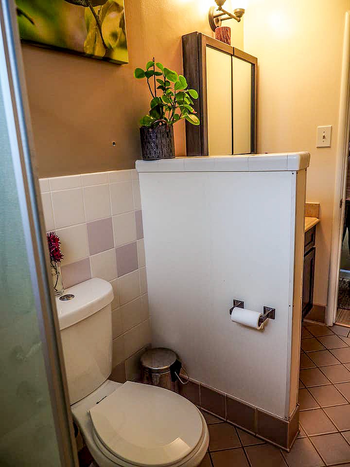 A bathroom with a lot of storage and shelves cabinets spaces
