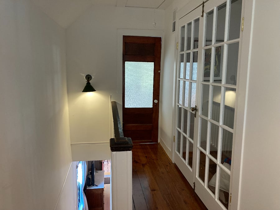 Upstairs hallway, door to master bedroom, french doors to second room