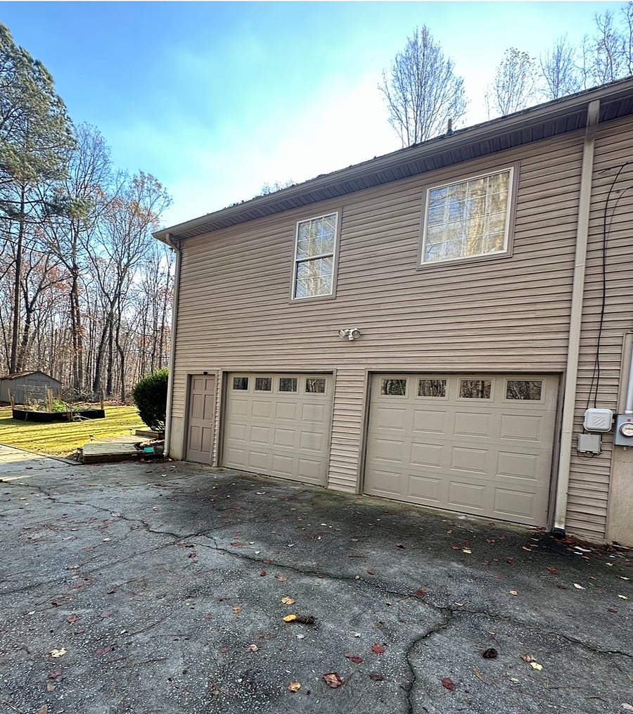 Entry door into garage next to garage doors