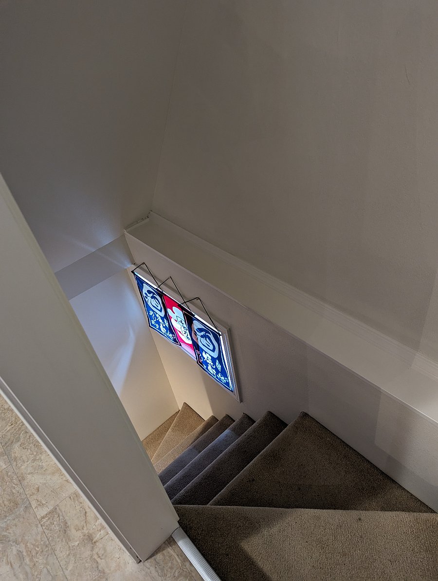 Stairs off the kitchen down to washer/dryer, bonus room, and back door to parking spot