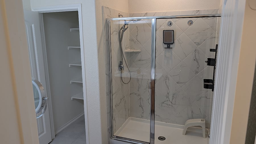 Primary bathroom with walk-in shower and adjoining closet