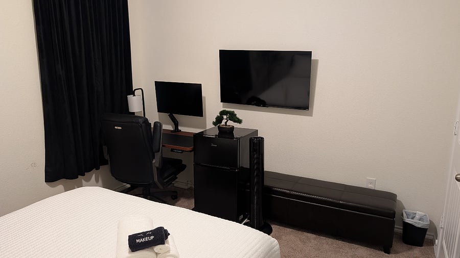 First-floor queen suite with workspace, mini-fridge, and Smart TV