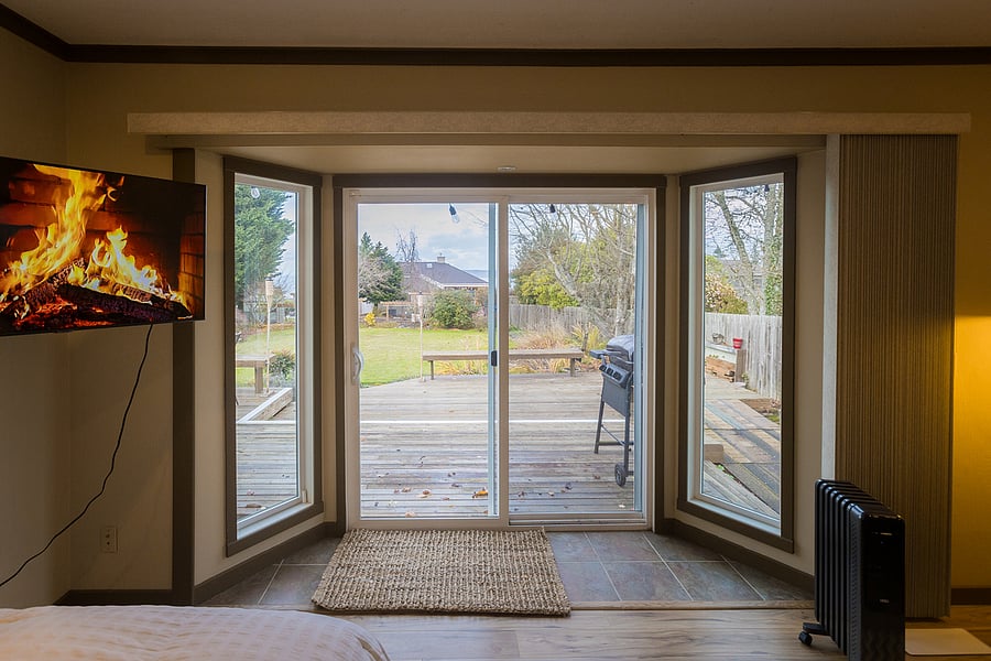 Sunny and bright private studio with large entry windows and sliding door.