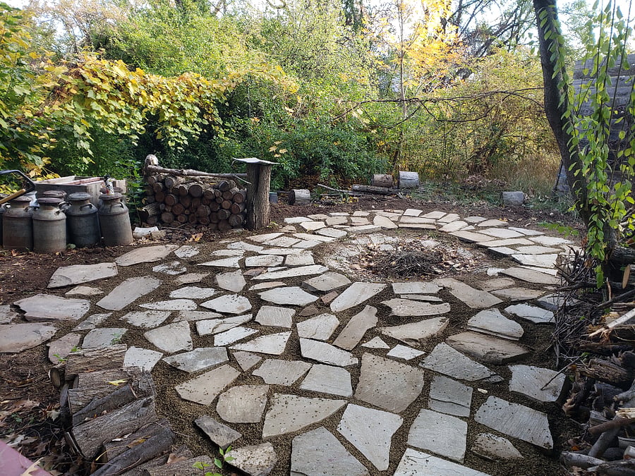 The fire pit in the way-back yard