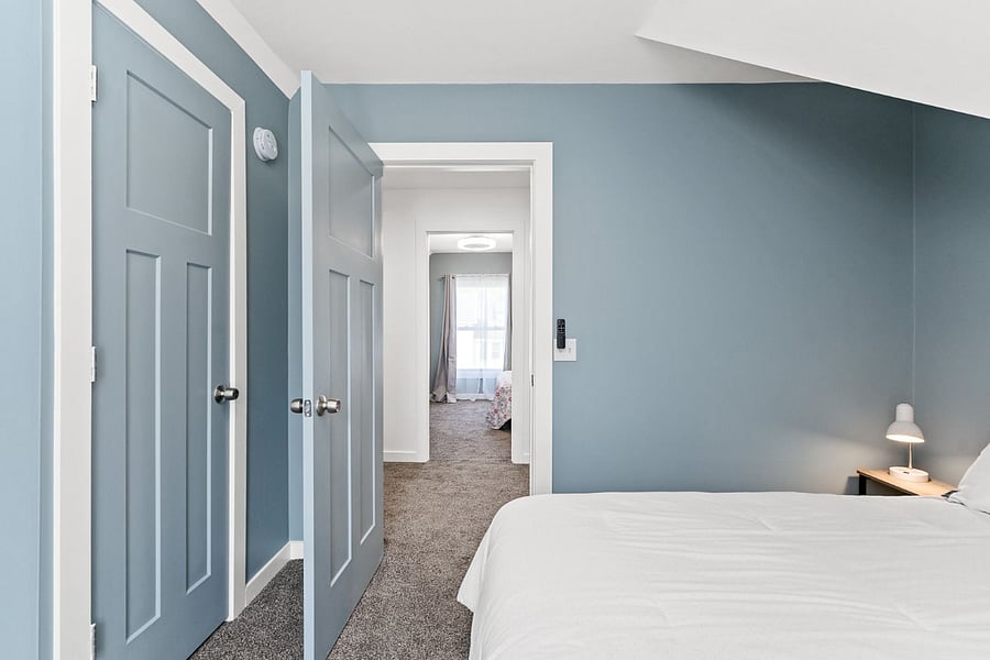 Looking from one bedroom across the hall into another bedroom