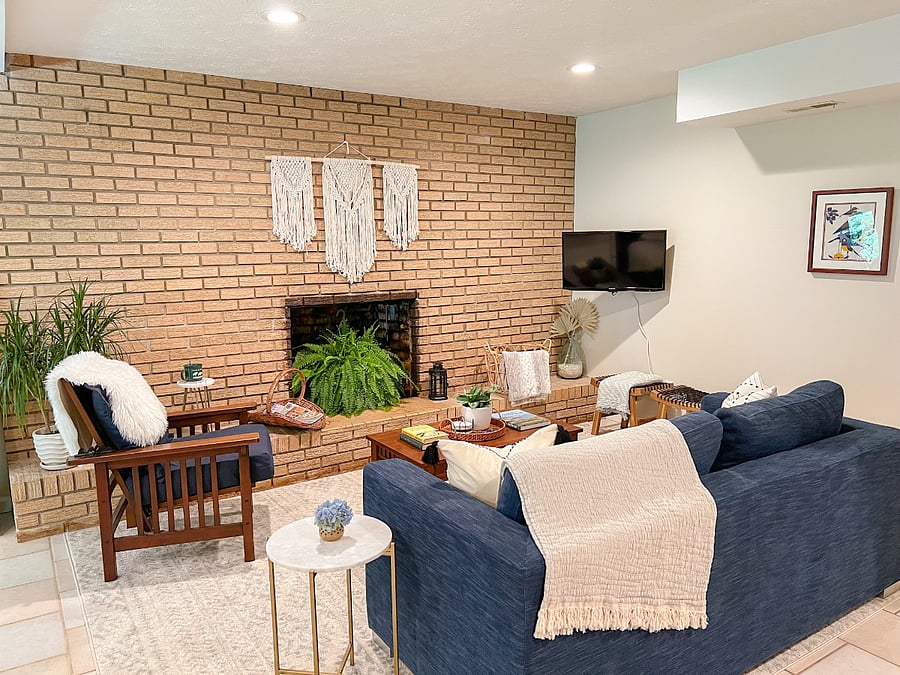 Living room has plenty of comfortable and cozy seating to relax while watching TV or reading a book.
