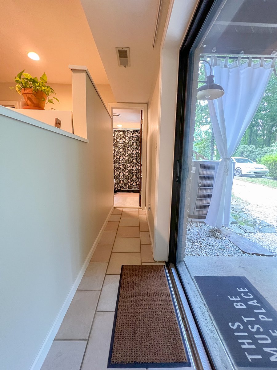 Narrow hallway at the entrance of the guest suite looking into the bathroom.