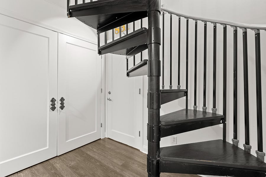 Spiral stairs lead to 2 bedroom and 1 bathroom on the upper level