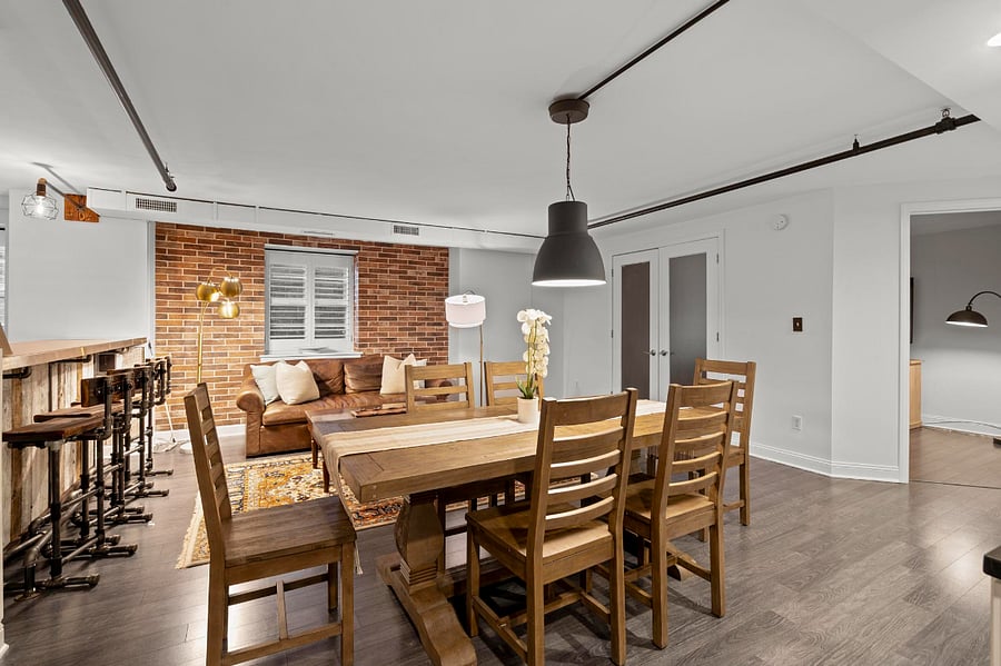 Dining table easily seats 6 with additional 4 person seating at the modern bar