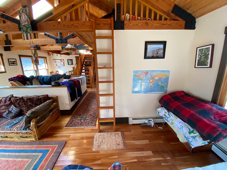 Living area with stairs leading up to a small loft area for children