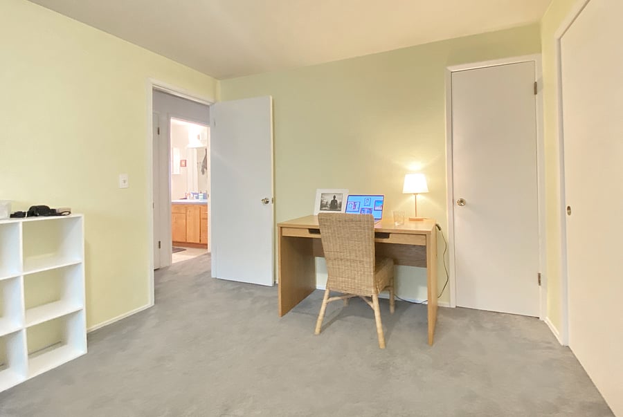 Your bedroom has a large desk and wood chair.