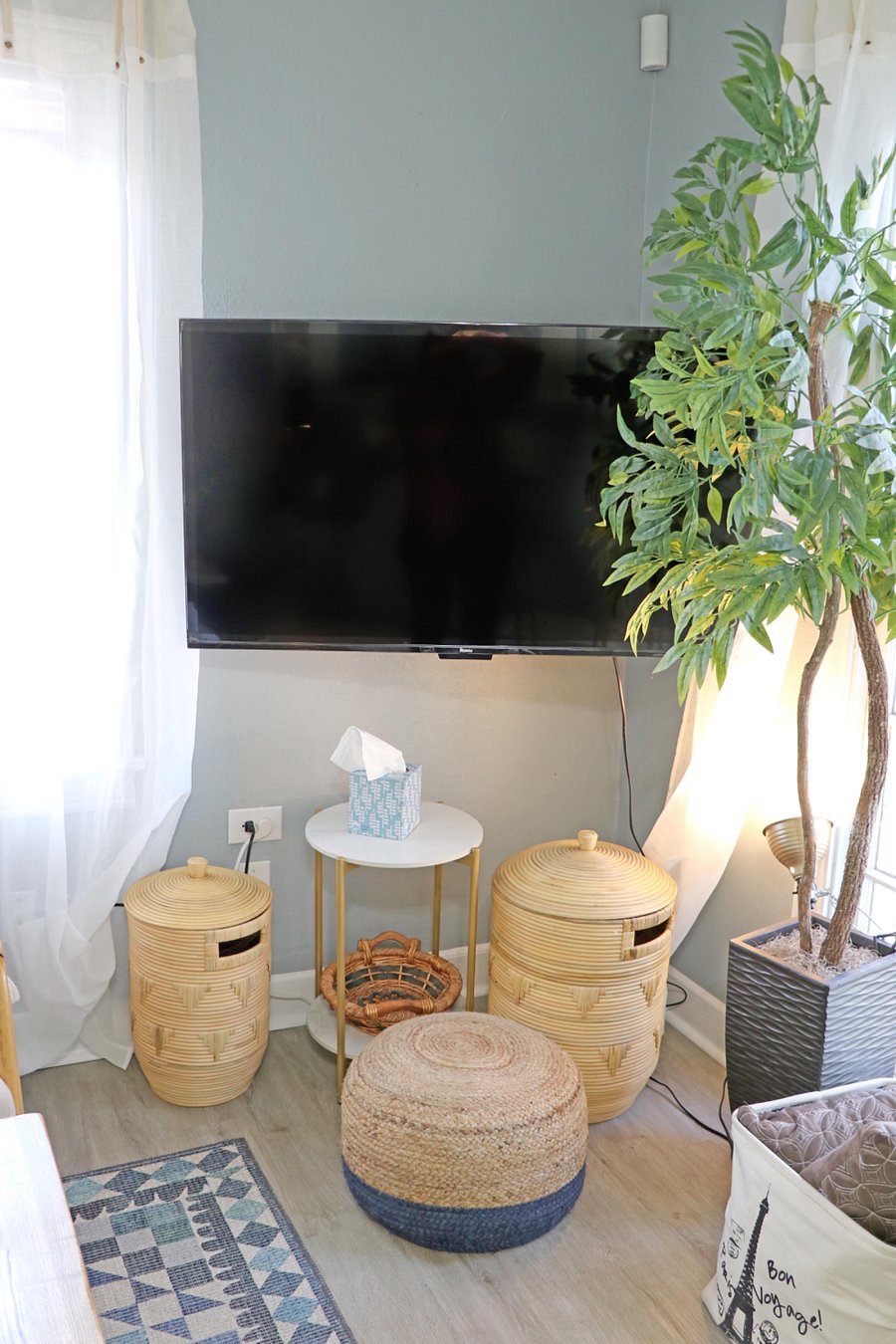 Wall mounted 50" Roku TV pulls out for best viewing position.