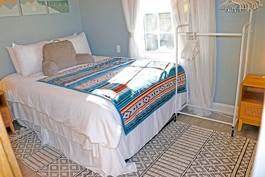 Clothes rack & plenty of underbed storage maximize the space.