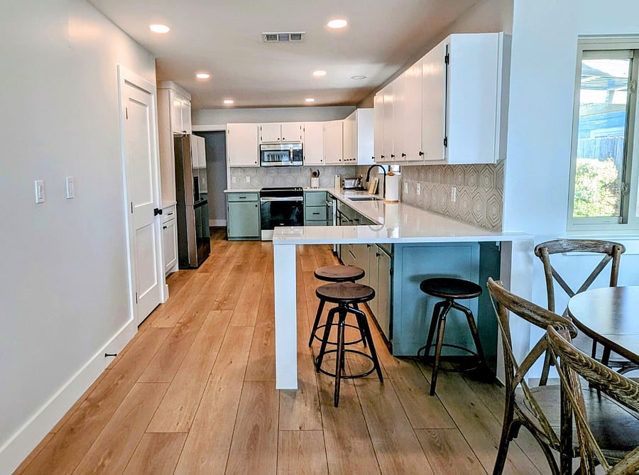 spacious kitchen with eat at kitchen bar with seating for 3
