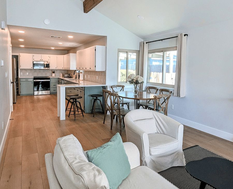 Living room view to dining area, breakfast bar and kitchen