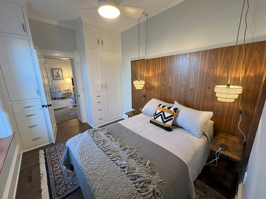 Small bedroom with full-sized bed and built-in closets