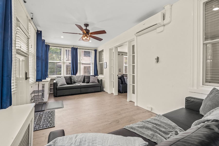 Wall remote controls are for the mini-split AC, which cools the front and back porches. Gas radiator heat is controlled from the Google Nest HVAC thermostat inside the central dining room. All ceilings are fully insulated for thermal and noise.