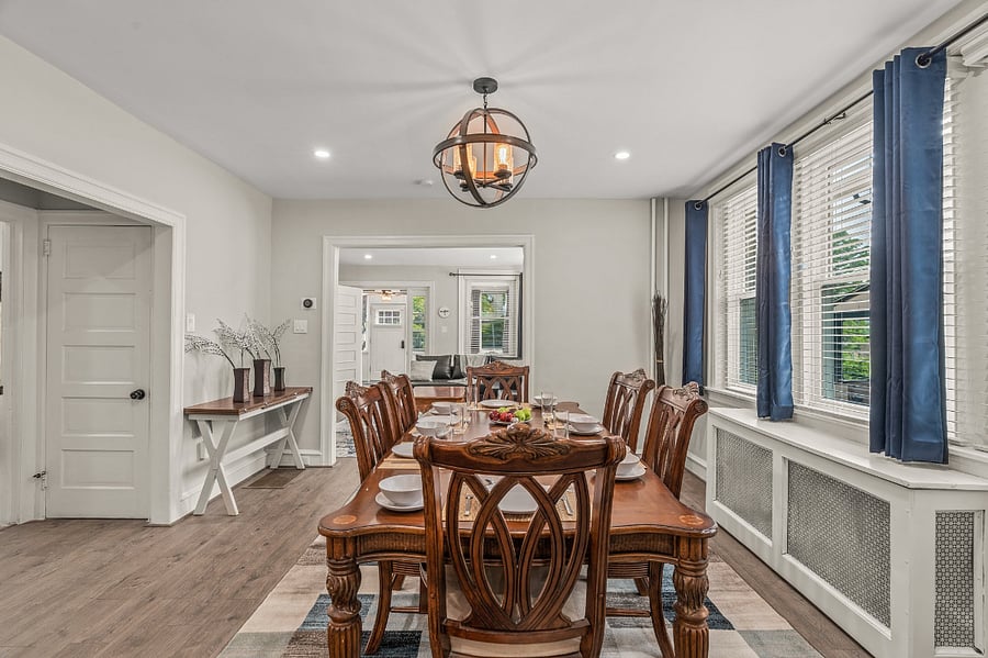 Large space and table comfortably sits six with extra dining room in kitchen island. Artistic early 1900s original toll house next door was lifted 100 feet to its current position, viewed through the windows. Dining room houses Google Nest thermostat