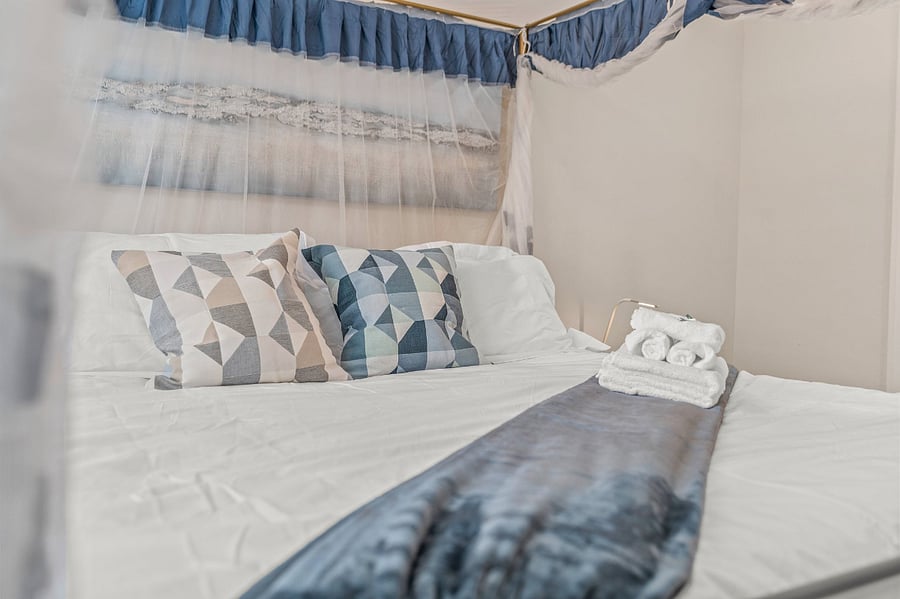 Spacious central bedroom with canopy bed and extra space inside the closet. Mints and clean linens await you in each bedroom. Which is your favorite bedroom? 