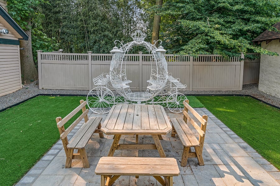 Enjoy a gated backyard with artificial grass (AstroTurf), paved patio, small deck, table and bench chairs, and a chariot-carriage for up to four VIPs! Please beware that adventurous children could walk out around the gaps at the backs of the garages