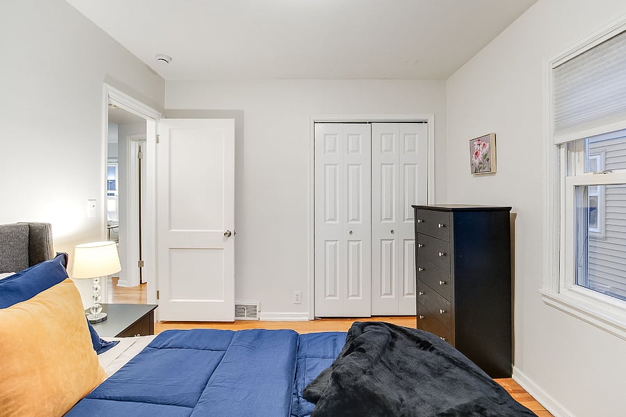 Main Floor Bedroom I with Queen Size Bed, Dresser, and Closet