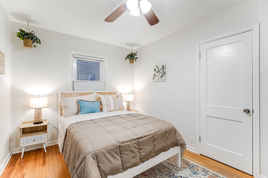 Main Floor Bedroom II With Double Bed, Dresser, and Closet