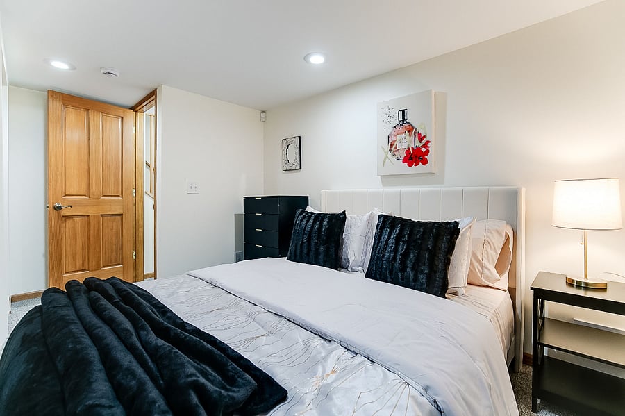 Lower Level Bedroom with Queen Size Bed, Dresser, and Closet