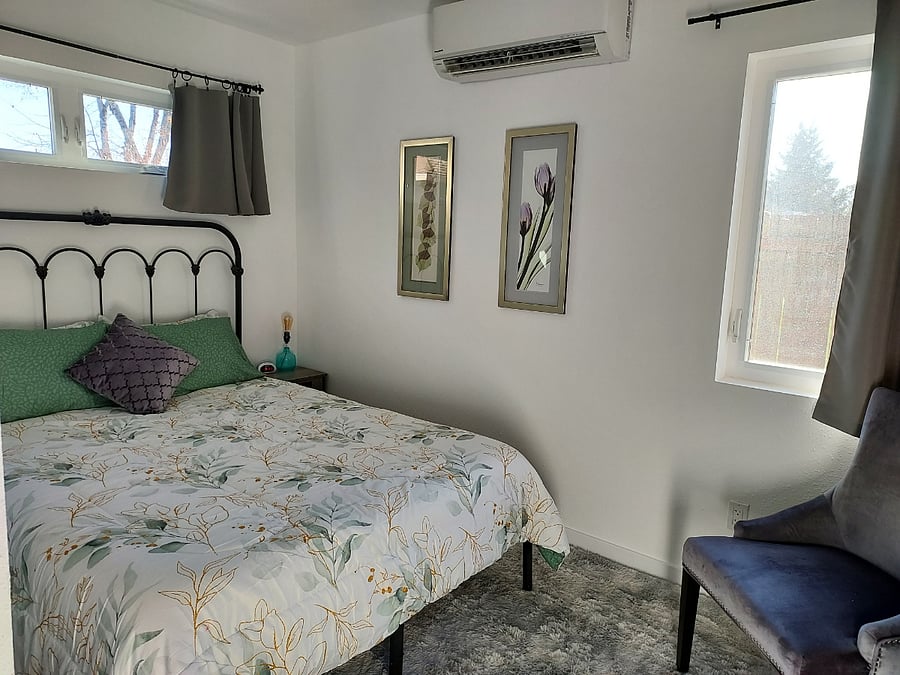 Bedroom side tables are outfitted with USB ports and plug-ins, plus digital alarm clock provided. Bedding includes additional blankets. Bedroom has its own dedicated separate ductless heating/cooling head unit.