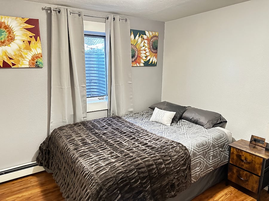 Bedroom with Queen Bed and Nightstand with charging capabilities