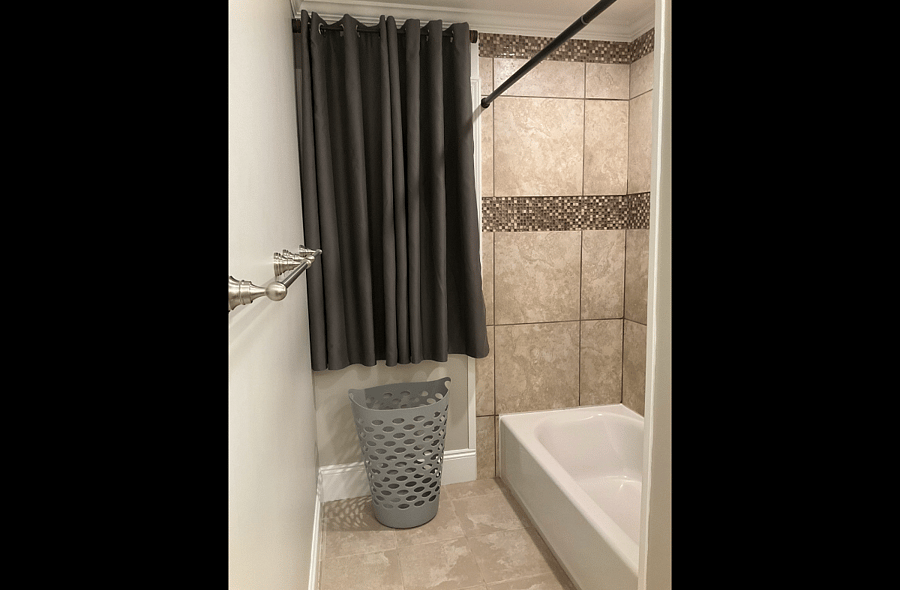 Standard Suite's Private Bath with Ceramic Tub and Full Tile Surround.