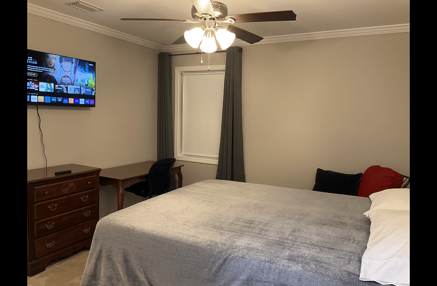 Standard Suite: bed, bedside table, sitting chair, dresser, desk and office chair, WiFi TV. Private bathroom.