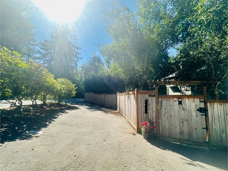 Dedicated parking space and gated entry to yard/unit and convenient pull through style driveway