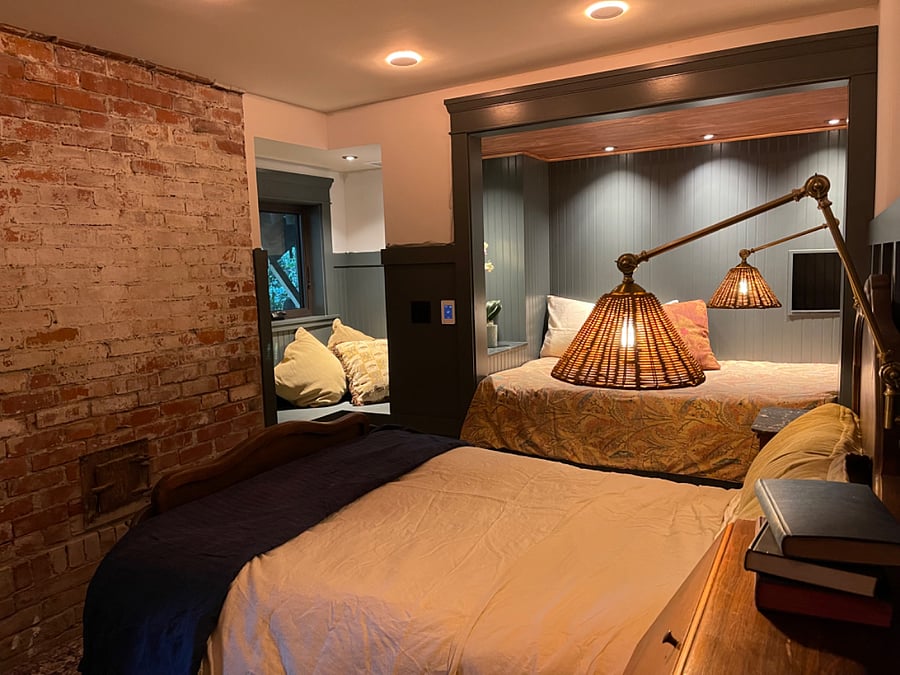 Guest room downstairs with antique full bed and twin bed sleeping nook. Window seat and views of the redwoods.