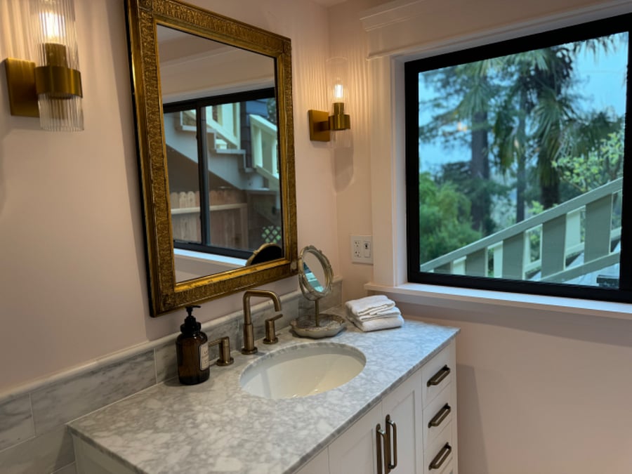 Downstairs primary suite marble bathroom.