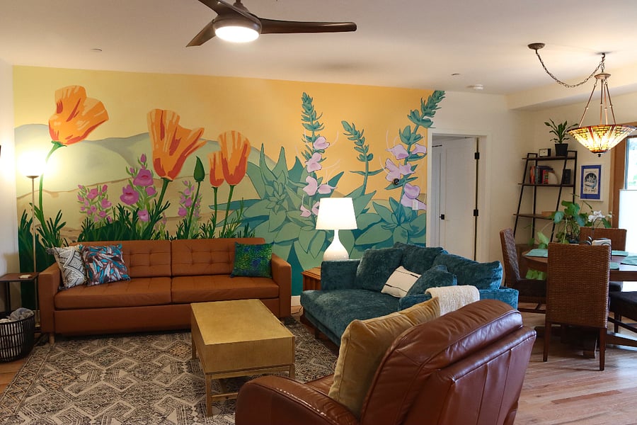 Living room and dining area for 4 with mural of CA poppies, penstemon, and white sage.