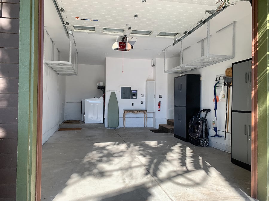 Garage with ironing board, iron, cleaning supplies, and stroller if you need it.