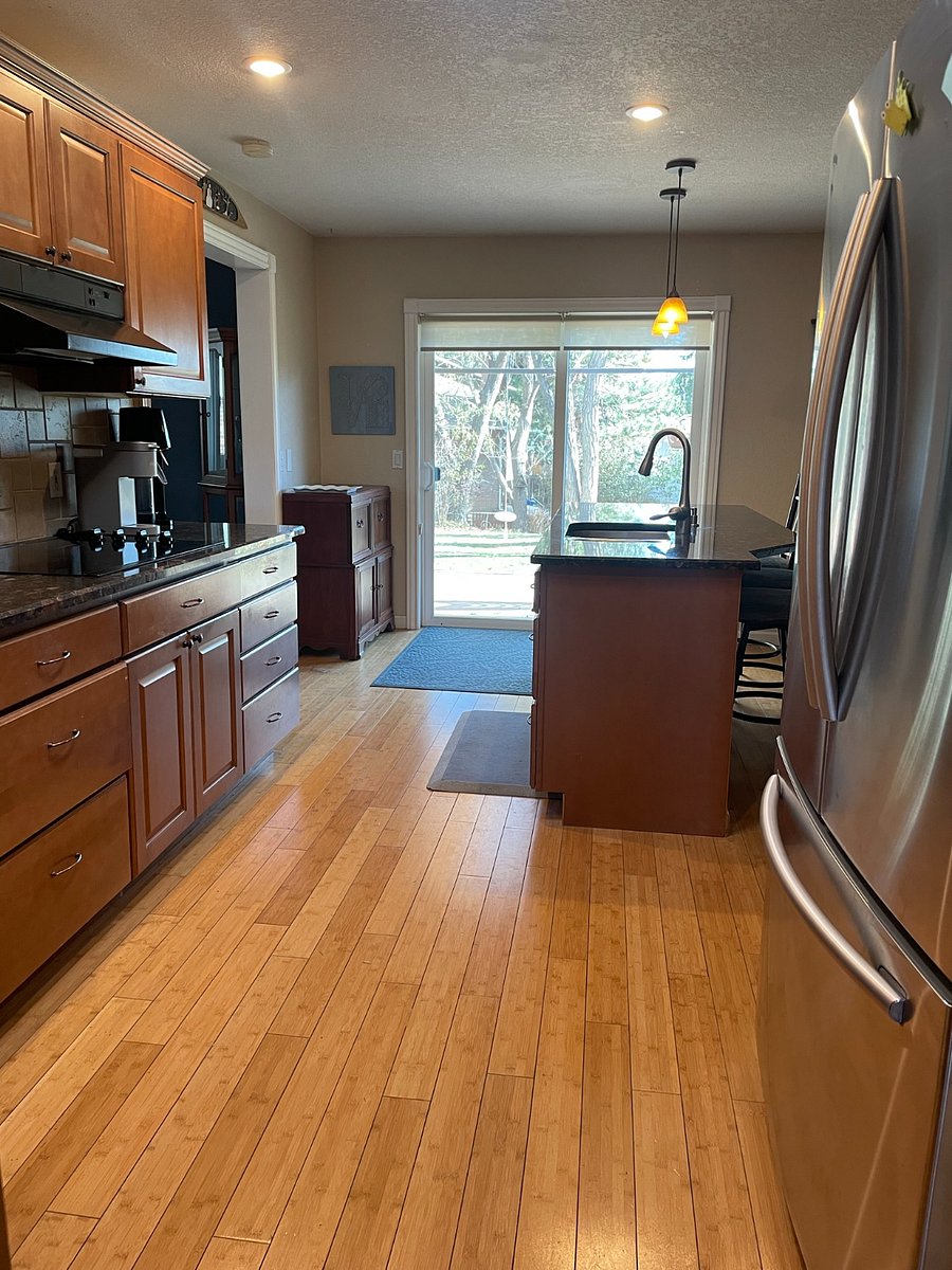 Kitchen includes sliding glass door for access to deck and back yard.